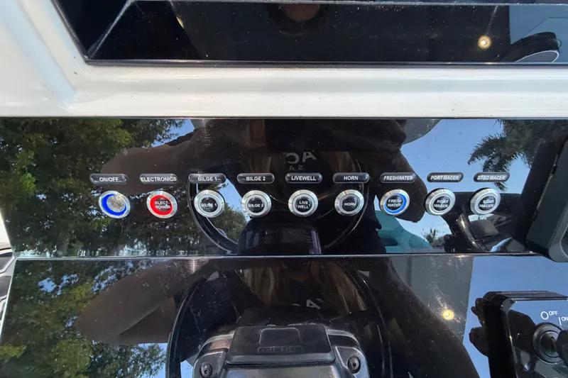 Slide: The Image of Control panel of a 2023 Sea Tech 33 boat with various switches and buttons. - 41