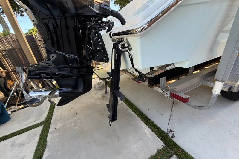 Slide: The Image of 2023 Sea Tech 33 boat engine and propeller on trailer, parked outdoors. - 12