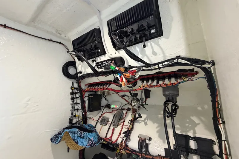 Slide: The Image of Electrical wiring setup in a 2023 Sea Tech 33 boat, showcasing organized cables and components. - 51