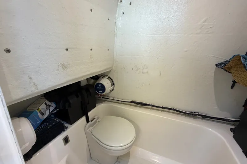 Slide: The Image of Compact marine bathroom in 2023 Sea Tech 33 boat, featuring a toilet and storage space. - 49
