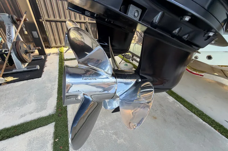 Slide: The Image of Shiny propeller of 2023 Sea Tech 33 boat in a garage setting. - 11