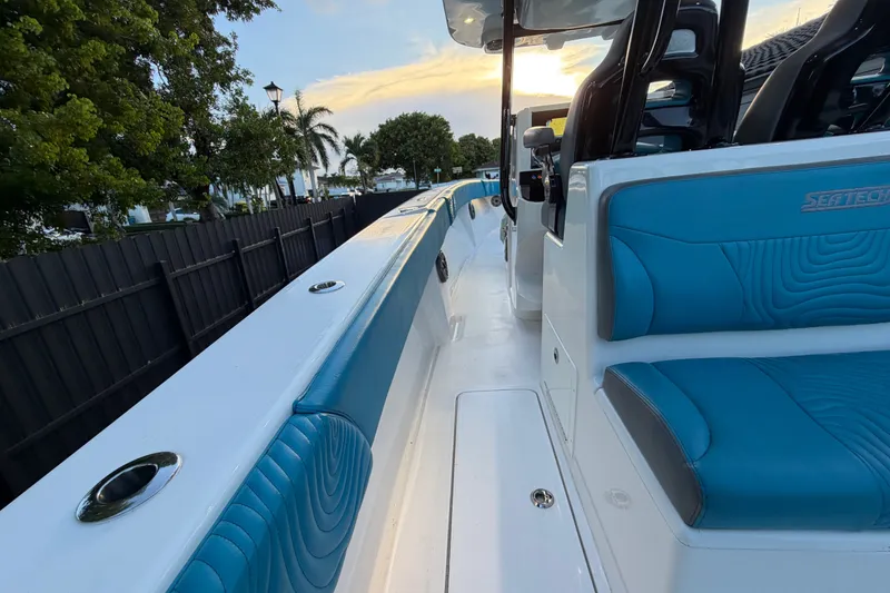 Slide: The Image of 2023 Sea Tech 33 boat with blue seating, sleek design, and modern features. - 27