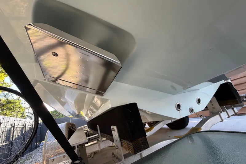 Slide: The Image of 2023 Sea Tech 33 boat hull with metal fittings on a trailer. - 5