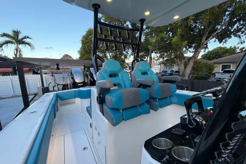 Slide: The Image of 2023 Sea Tech 33 boat interior with blue seating and modern controls. - 31