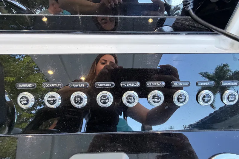 Slide: The Image of Control panel of a 2023 Sea Tech 33 boat with various labeled switches. - 40