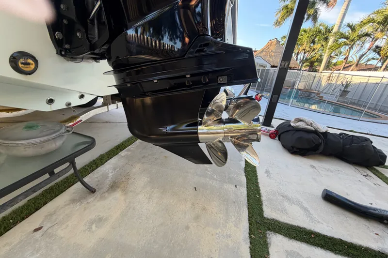 Slide: The Image of 2023 Sea Tech 33 boat propeller, shiny and metallic, near a poolside setting. - 3