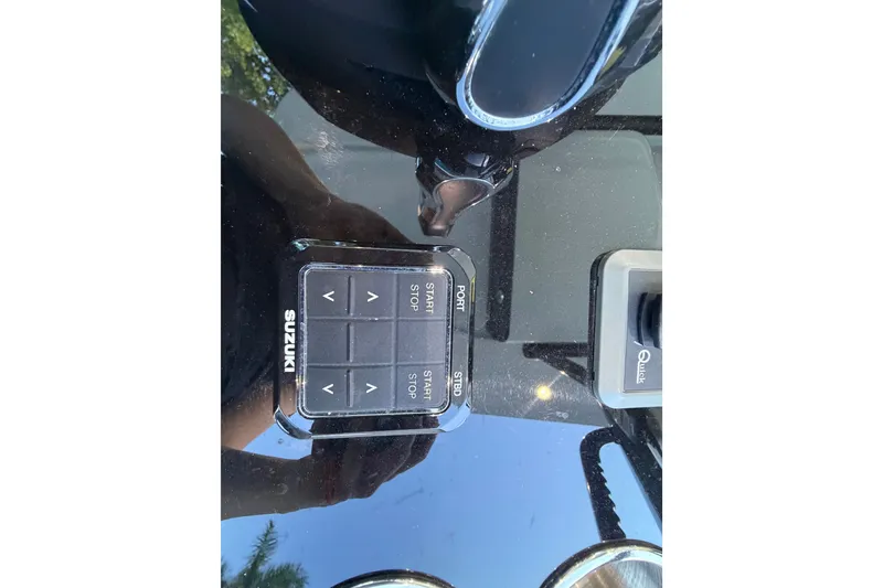 Slide: The Image of Control panel of a 2023 Sea Tech 33 boat with Suzuki buttons. - 35