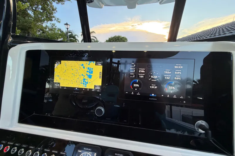 Slide: The Image of Dashboard of 2023 Sea Tech 33 boat with Garmin navigation displays. - 46
