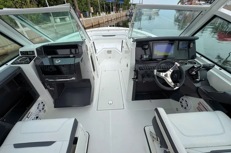 Slide: The Image of 2022 Blackfin 252 DC boat interior with modern dashboard and seating. - 16