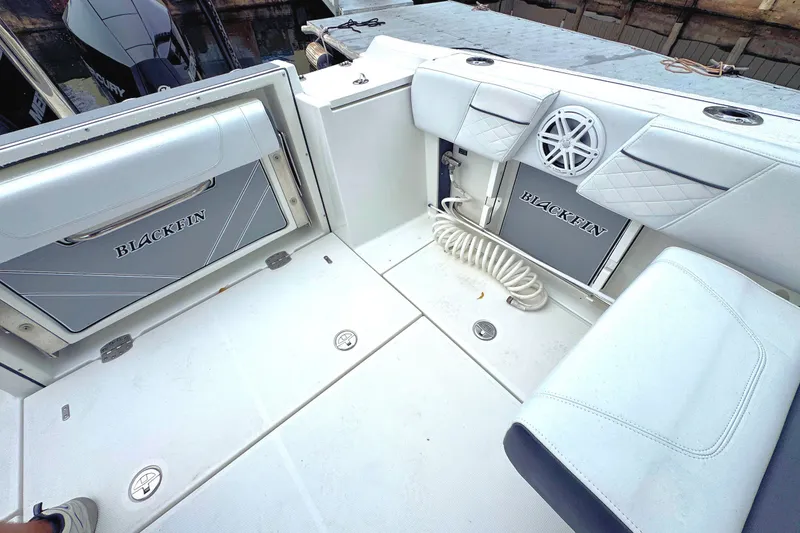 Slide: The Image of 2022 Blackfin 252 DC boat interior with seating and storage compartments. - 14
