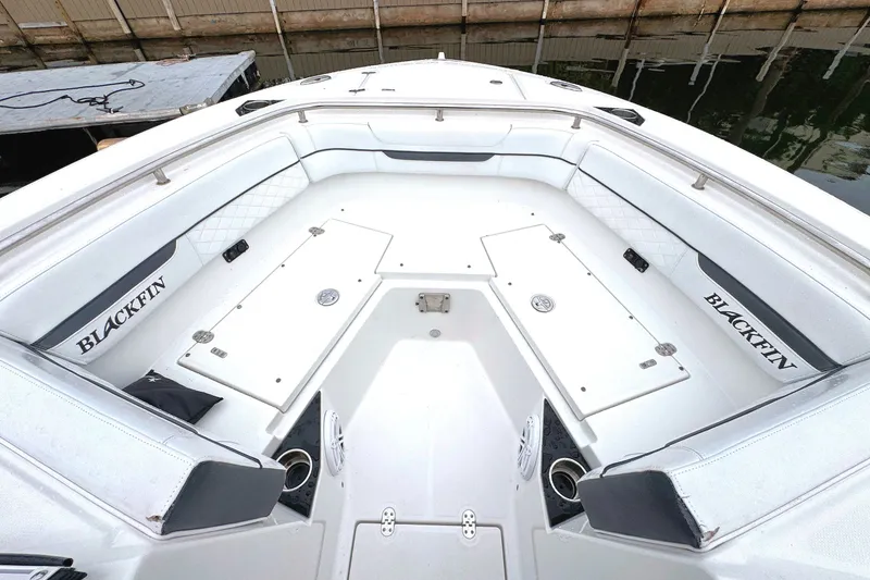 Slide: The Image of 2022 Blackfin 252 DC boat interior with spacious seating and storage compartments. - 19