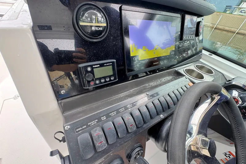 Slide: The Image of 2022 Blackfin 252 DC dashboard with navigation controls and Garmin display. - 17