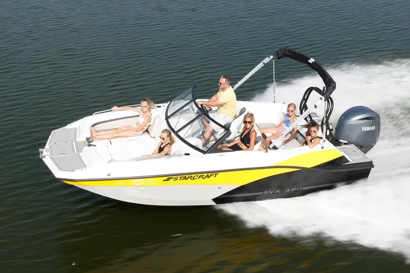 Slide: The Image of Manufacturer Provided Image: 2026 Starcraft SVX 190 DC OB boat cruising with passengers on a sunny day. - 2