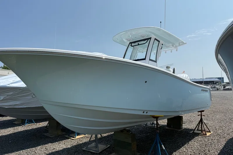 The Image of 2027 Sportsman Open 232 Center Console boat on display in a marina setting. - 0