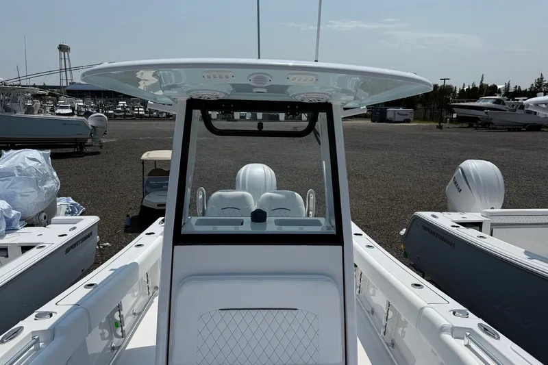 Slide: The Image of 2027 Sportsman Open 232 Center Console boat at a marina, showcasing helm and seating. - 4