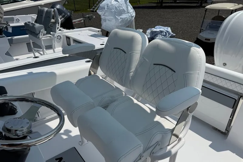 Slide: The Image of 2027 Sportsman Open 232 Center Console boat with white cushioned seating. - 6