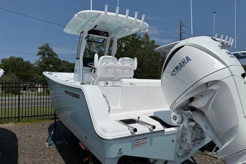 Slide: The Image of 2027 Sportsman Open 232 Center Console boat with Yamaha engine, parked outdoors. - 1