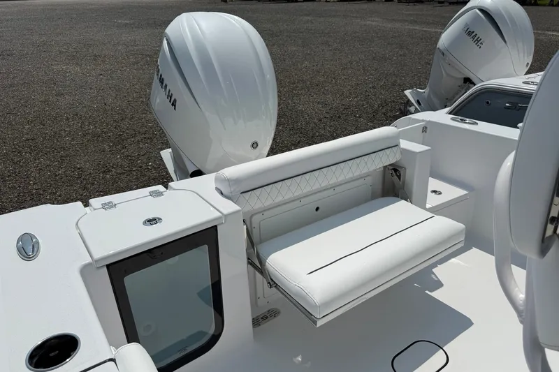 Slide: The Image of 2027 Sportsman Open 232 Center Console boat with Yamaha engines, featuring a white cushioned seat. - 11