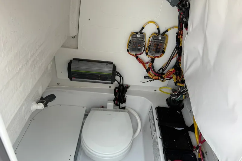 Slide: The Image of Interior of 2027 Sportsman Open 232 Center Console boat, featuring wiring and equipment. - 9