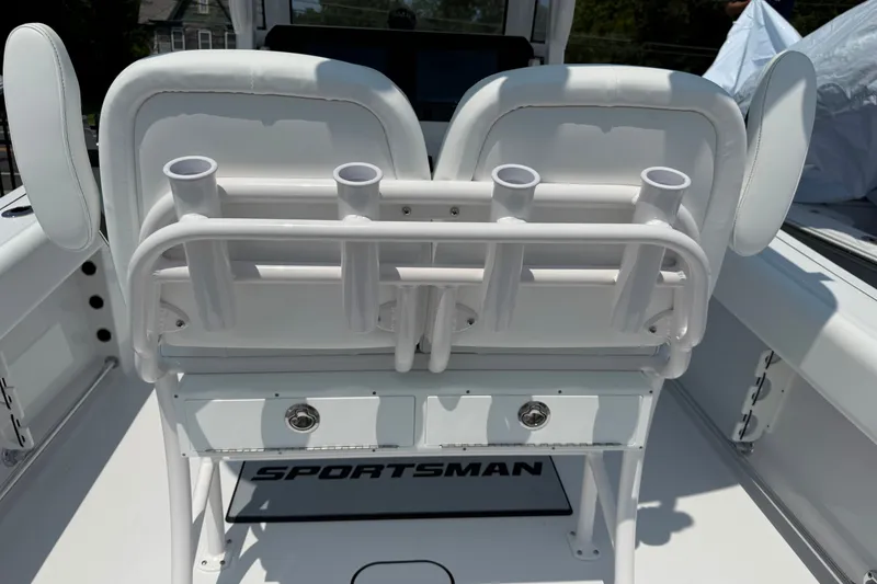 Slide: The Image of 2027 Sportsman Open 232 Center Console boat with rod holders and cushioned seating. - 12