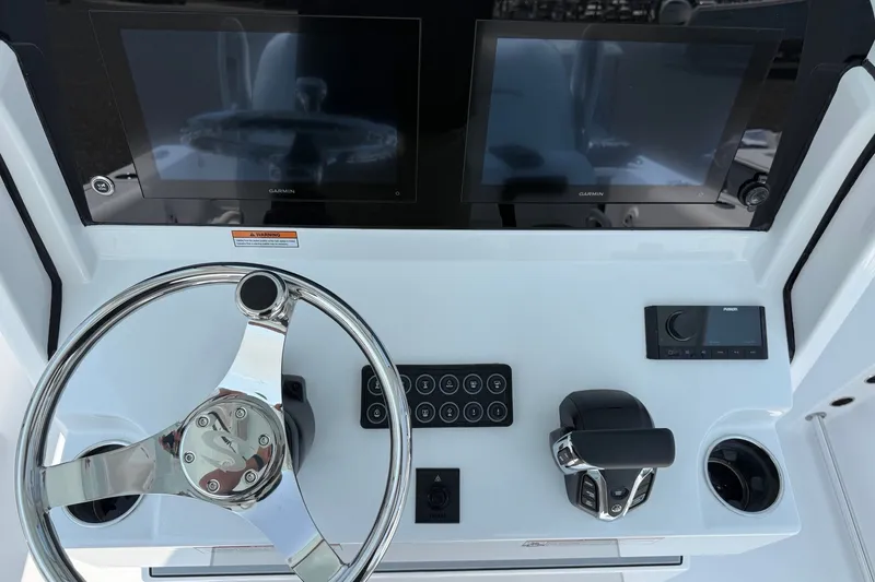 Slide: The Image of 2027 Sportsman Open 232 Center Console dashboard with dual Garmin displays and steering wheel. - 7
