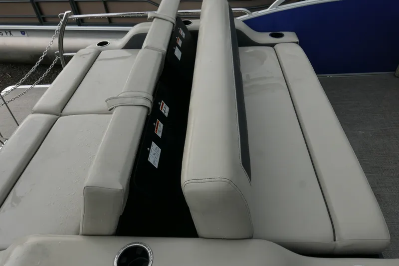 Slide: The Image of 2023 Barletta Cabrio 22UC boat interior seating with cup holder and storage. - 11