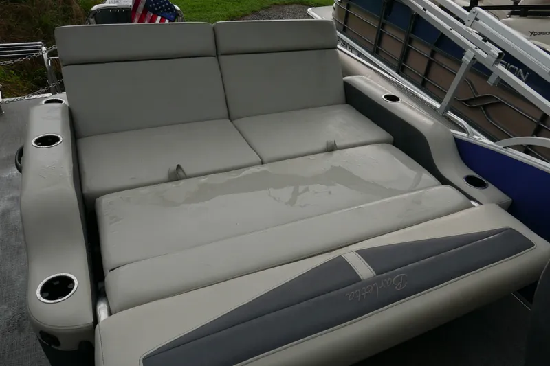 Slide: The Image of 2023 Barletta Cabrio 22UC boat interior with convertible seating and cup holders. - 14