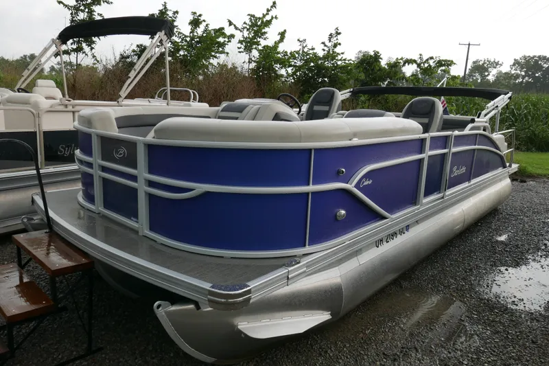 The Image of 2023 Barletta Cabrio 22UC pontoon boat with blue exterior, parked on gravel. - 0