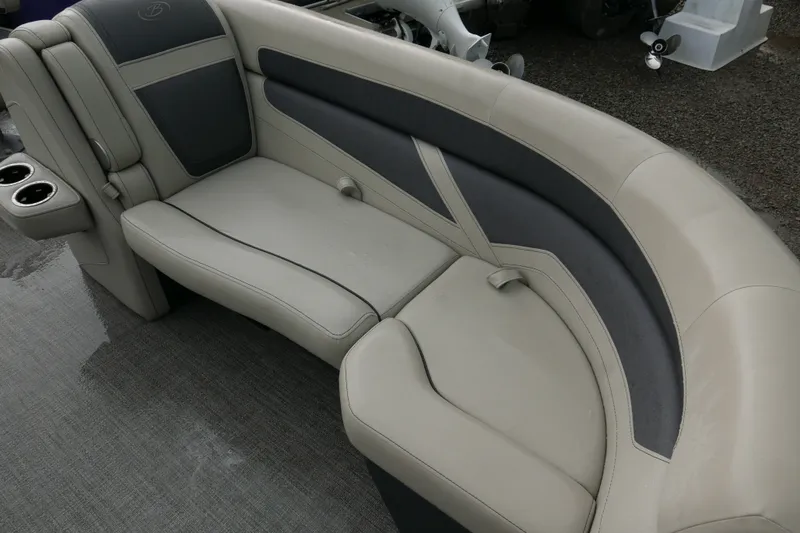Slide: The Image of 2023 Barletta Cabrio 22UC boat seating with beige and gray upholstery, featuring cup holders. - 6