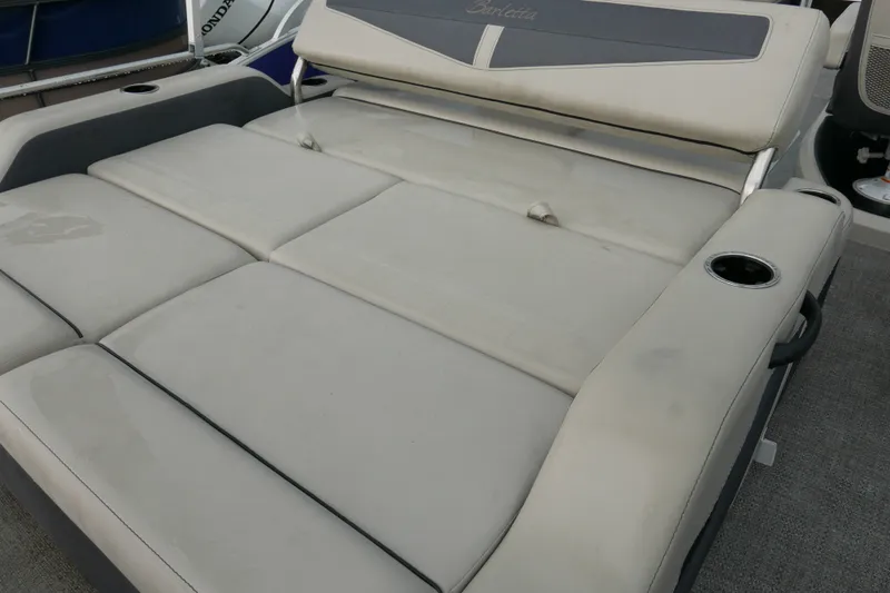 Slide: The Image of 2023 Barletta Cabrio 22UC boat with spacious, cushioned seating and integrated cup holders. - 12