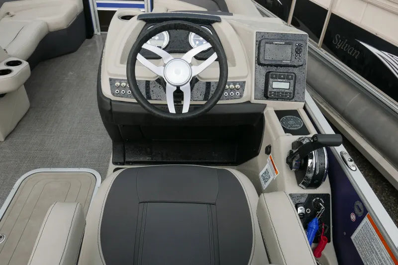 Slide: The Image of 2023 Barletta Cabrio 22UC boat dashboard with steering wheel and control panel. - 10