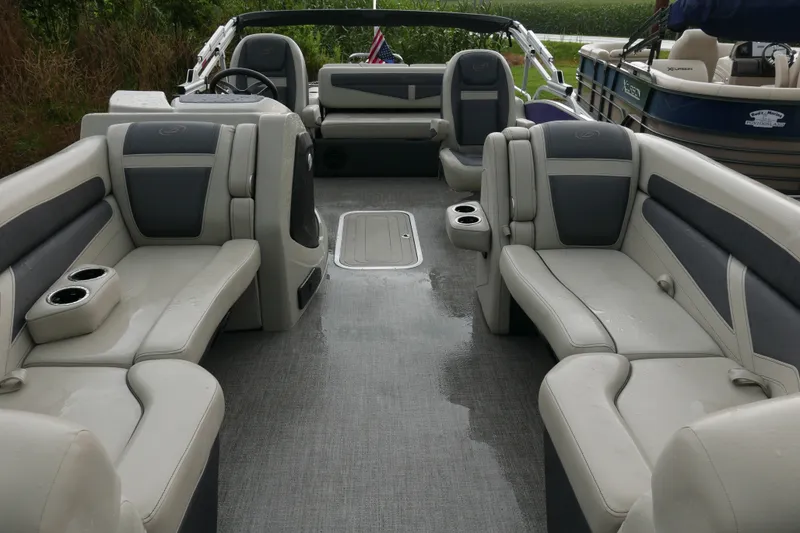 Slide: The Image of 2023 Barletta Cabrio 22UC pontoon boat interior with spacious seating and cup holders. - 4