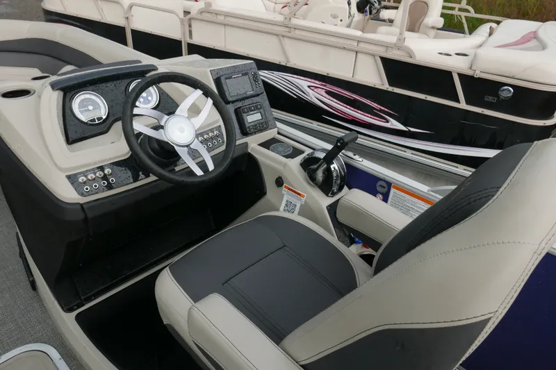 Slide: The Image of 2023 Barletta Cabrio 22UC boat cockpit with steering wheel and control panel. - 9