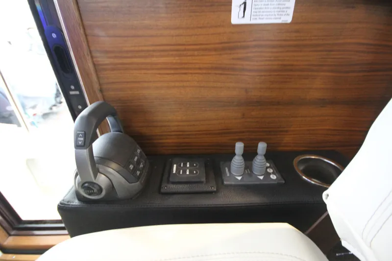 Slide: The Image of Control panel of 2026 Ranger Tugs R-31 CB with joystick and throttle controls. - 48