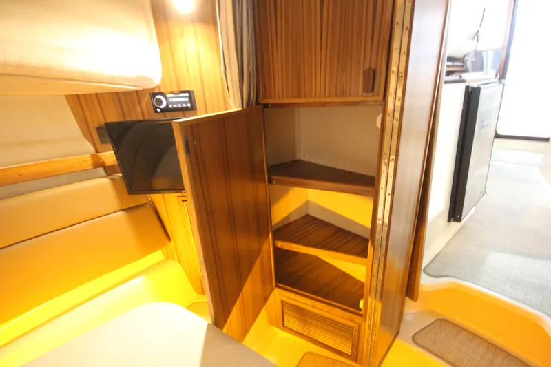Slide: The Image of Interior of 2026 Ranger Tugs R-31 CB with open wooden cabinet and seating area. - 55