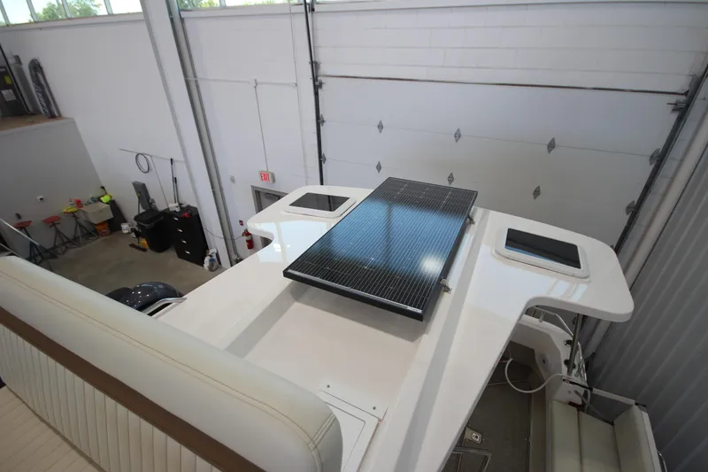 Slide: The Image of 2026 Ranger Tugs R-31 CB boat with solar panel on deck in a garage. - 24
