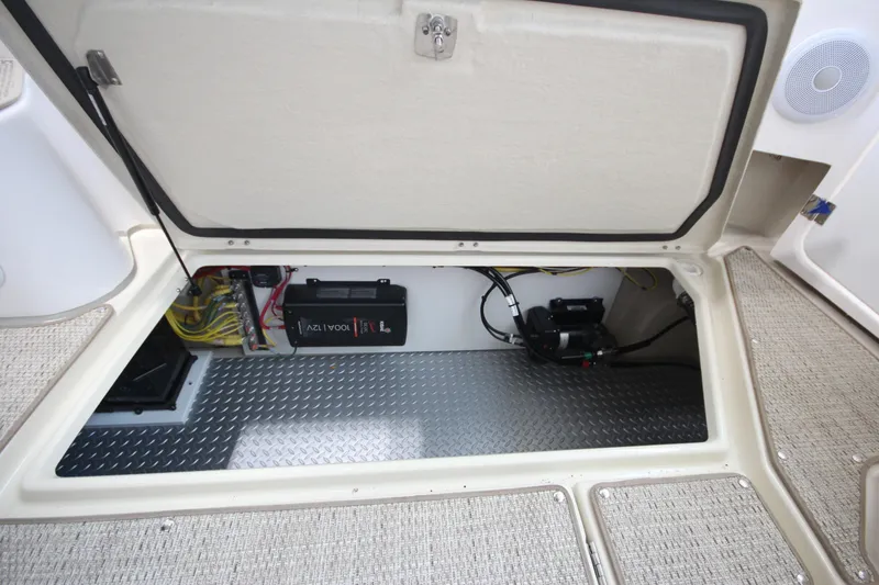 Slide: The Image of 2026 Ranger Tugs R-31 CB boat storage compartment with battery and wiring. - 18