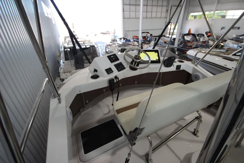 Slide: The Image of 2026 Ranger Tugs R-31 CB helm station with modern controls and navigation equipment. - 26