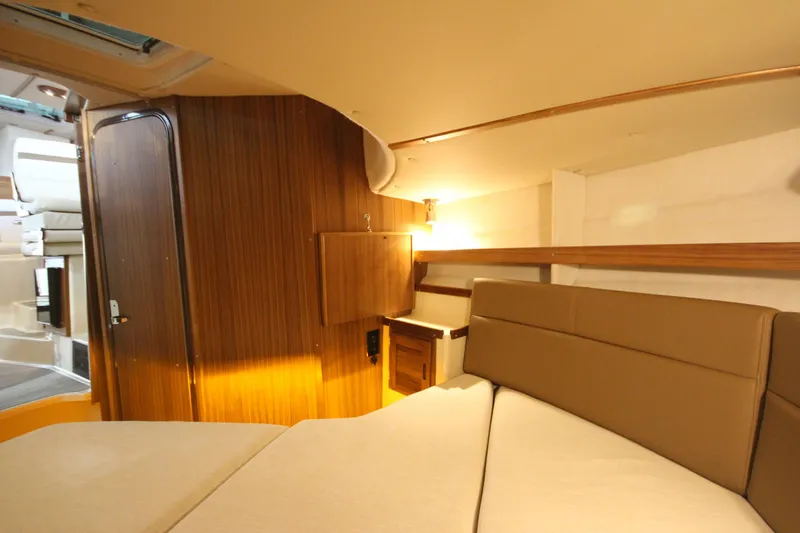 Slide: The Image of Interior cabin of 2026 Ranger Tugs R-31 CB, featuring wood paneling and cozy seating. - 54