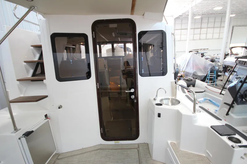 Slide: The Image of Interior view of 2026 Ranger Tugs R-31 CB boat with stairs and kitchenette. - 29