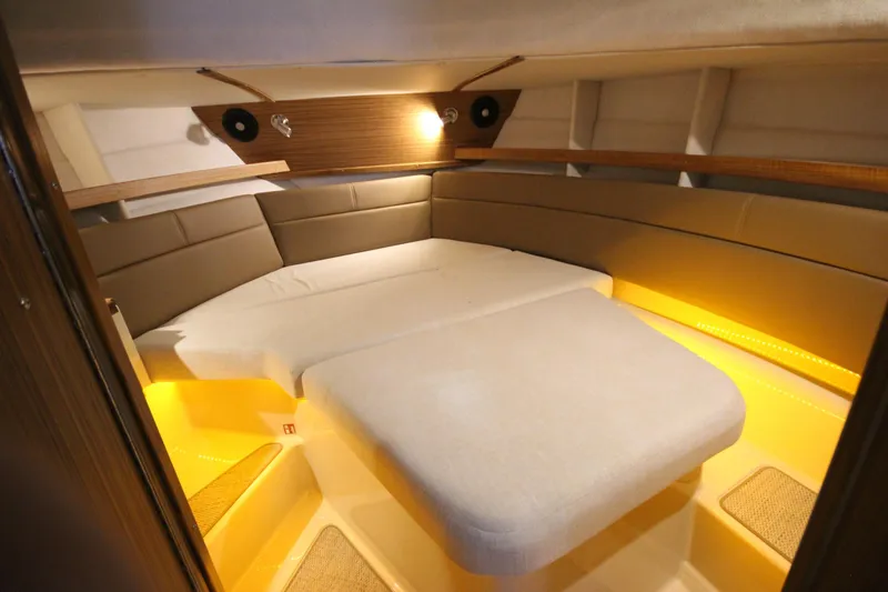 Slide: The Image of Cozy interior cabin of 2026 Ranger Tugs R-31 CB with ambient lighting. - 52