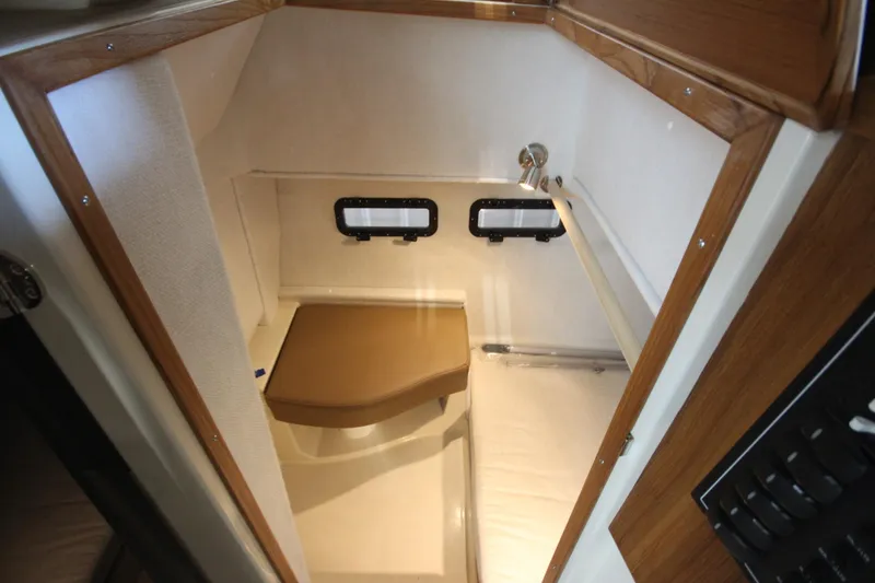 Slide: The Image of 2026 Ranger Tugs R-31 CB interior cabin with wooden trim and small windows. - 33