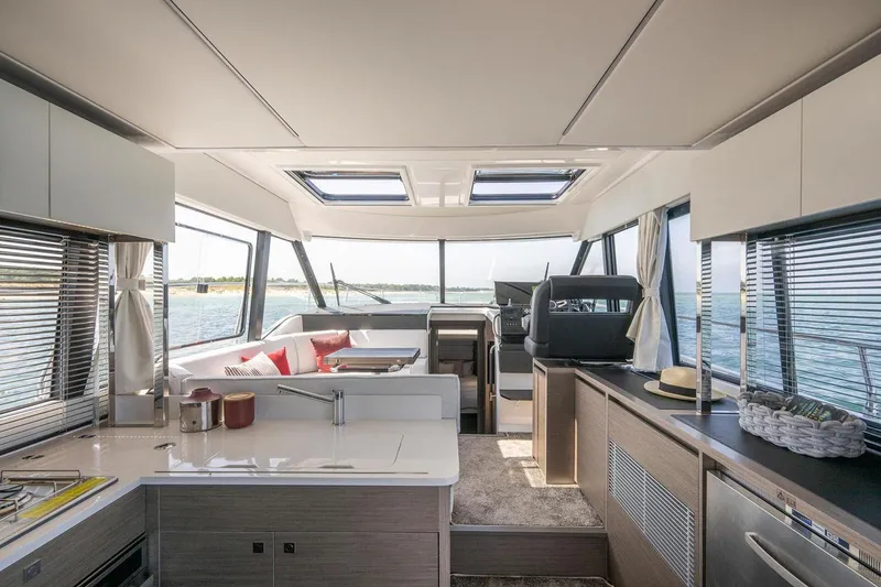Slide: The Image of Manufacturer Provided Image: Interior of 2025 Jeanneau NC 1295 Coupe yacht with modern design and panoramic windows. - 13