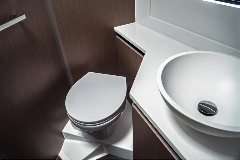 Slide: The Image of Modern bathroom interior of 2025 Jeanneau NC 1295 Coupe yacht, featuring sleek sink and toilet. - 30