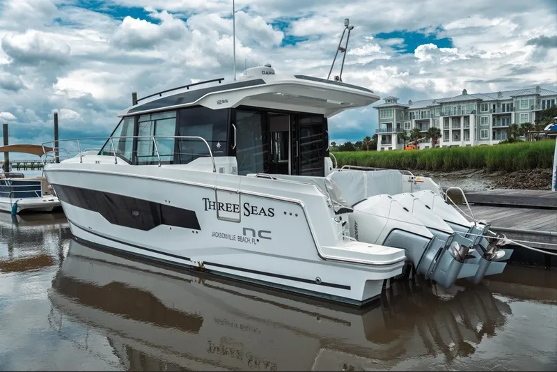 The Image of 2025 Jeanneau NC 1295 Coupe docked, featuring sleek design and powerful engines. - 0