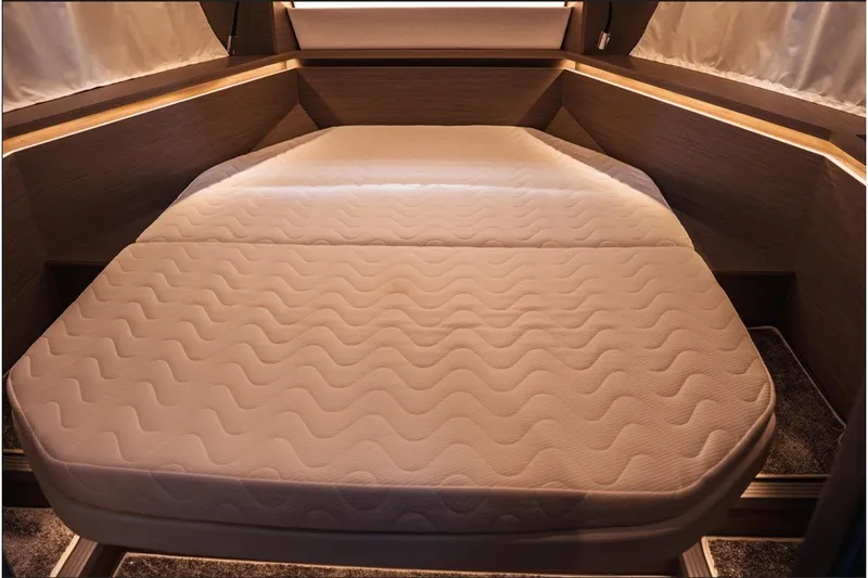 Slide: The Image of Luxurious cabin interior of 2025 Jeanneau NC 1295 Coupe with comfortable bedding. - 25