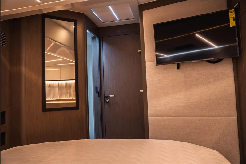 Slide: The Image of Interior of 2025 Jeanneau NC 1295 Coupe with modern decor and wall-mounted TV. - 29