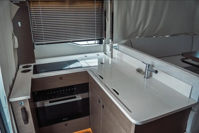 Slide: The Image of Modern kitchen interior of 2025 Jeanneau NC 1295 Coupe yacht with sleek design and appliances. - 19