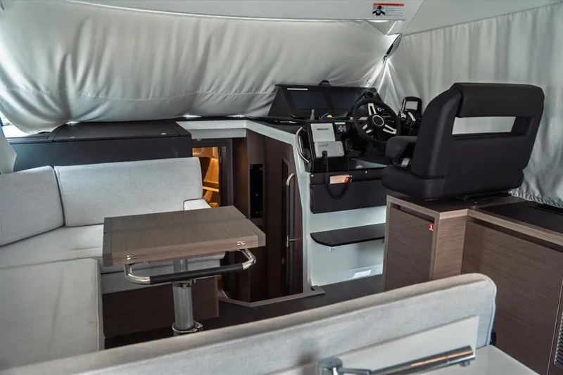 Slide: The Image of Interior of 2025 Jeanneau NC 1295 Coupe, featuring modern helm and seating area. - 14