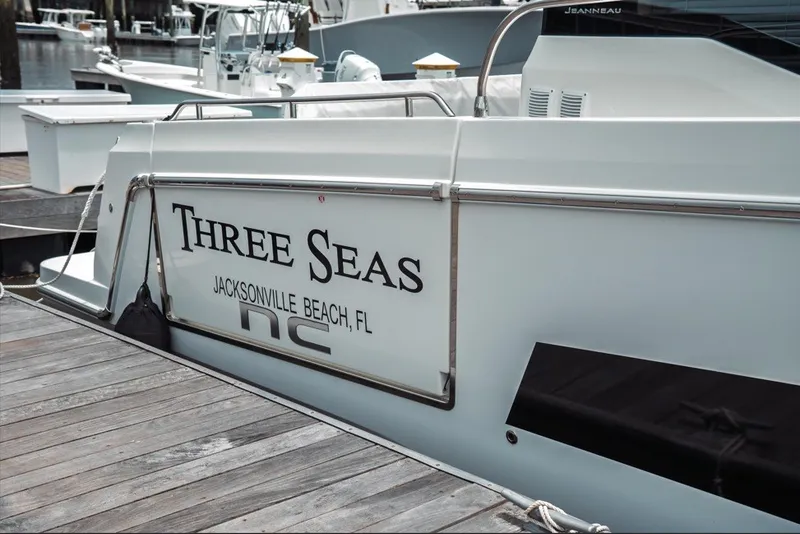 Slide: The Image of 2025 Jeanneau NC 1295 Coupe docked, named "Three Seas," Jacksonville Beach, FL. - 6